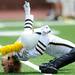 Michigan drum major, senior Jeffrey McMahon, touches his head to the turf while doing the traditional back bend during pregame against Eastern Michigan at Michigan Stadium on Saturday. Melanie Maxwell I AnnArbor.com